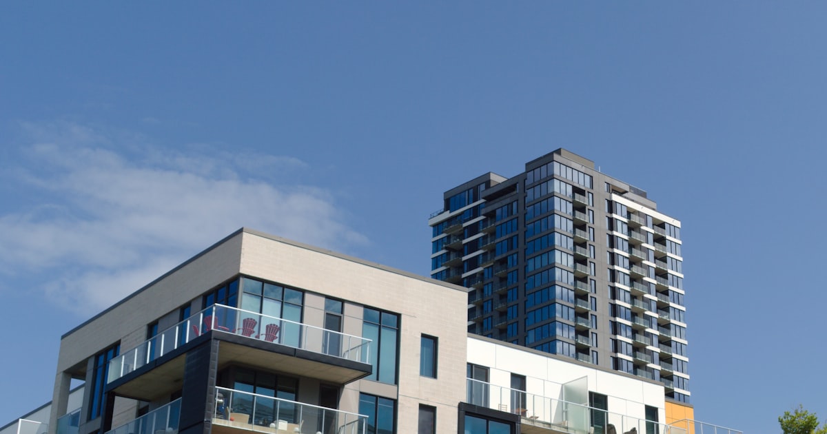 Modern condo and apartment buildings against a blue sky